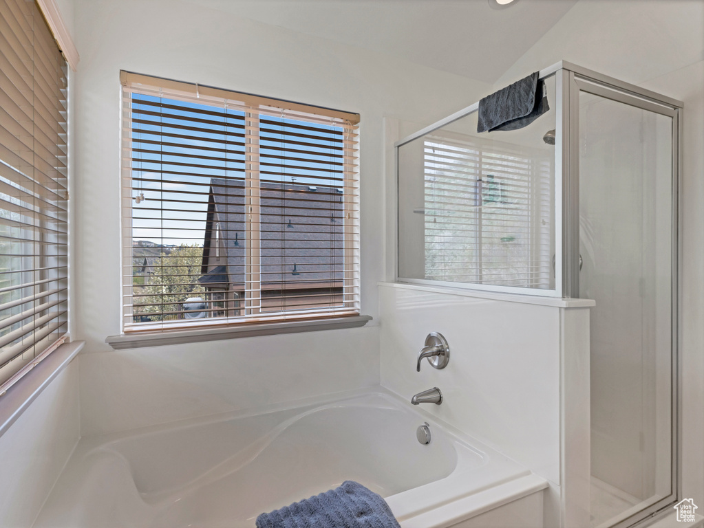 Bathroom featuring a stall shower and a bath