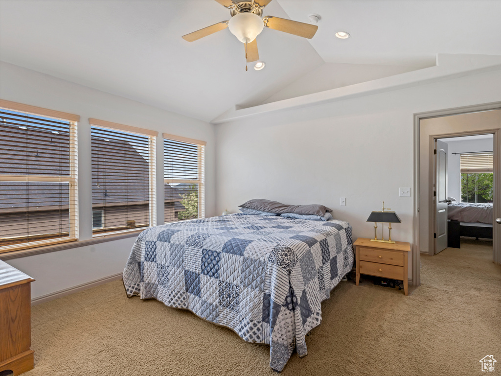 Bedroom with vaulted ceiling, light carpet, a ceiling fan, and recessed lighting