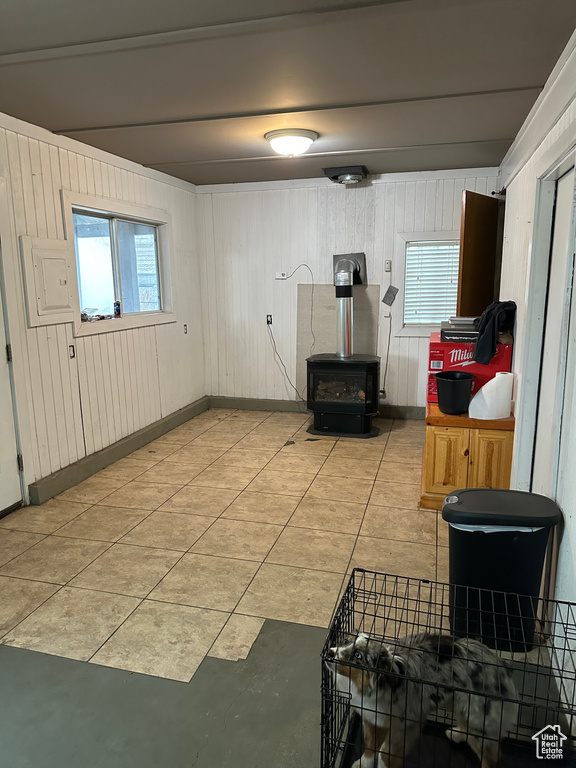 Kitchen featuring a wood stove and wooden walls