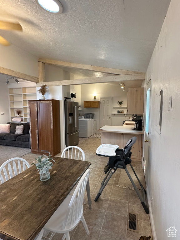 Dining space featuring vaulted ceiling, a ceiling fan, and a textured ceiling