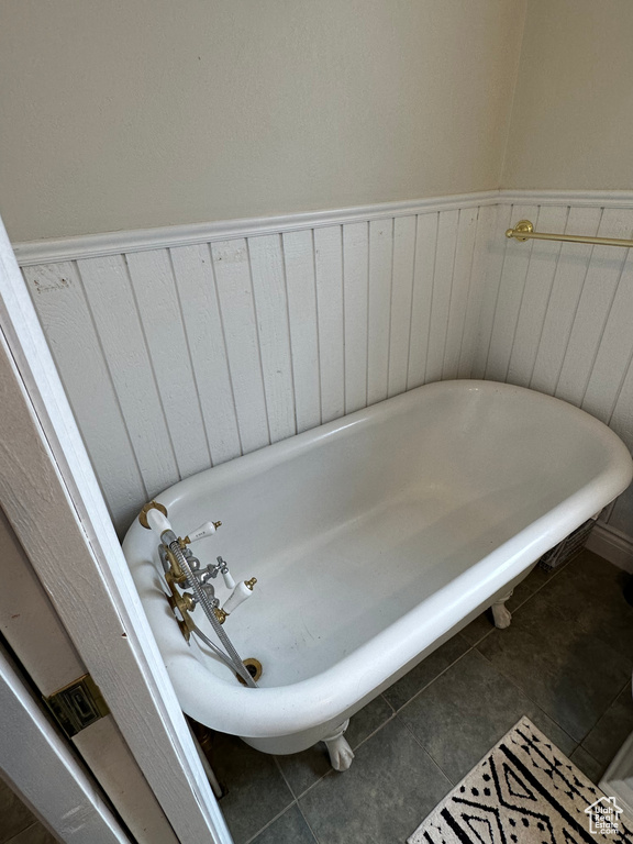 Full bathroom featuring a freestanding bath and tile patterned flooring