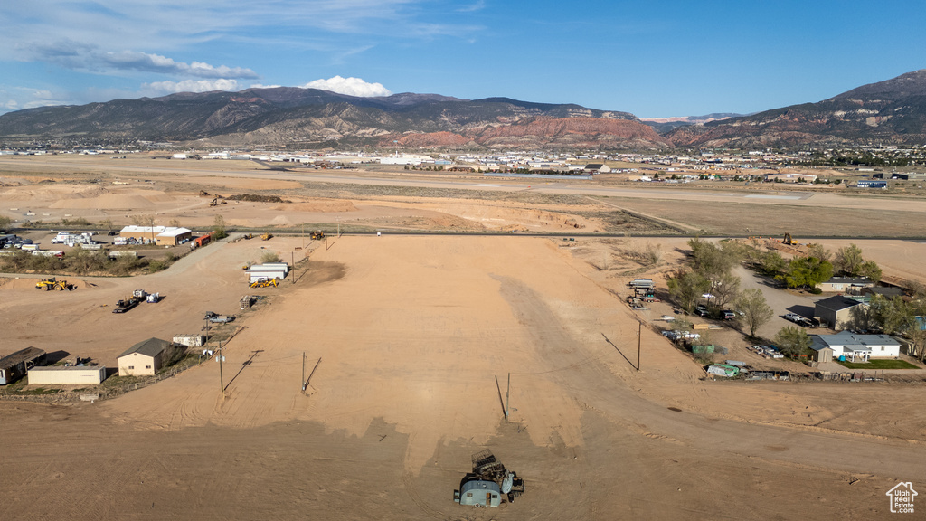 Aerial view of property and surrounding area featuring mountains and rural landscape