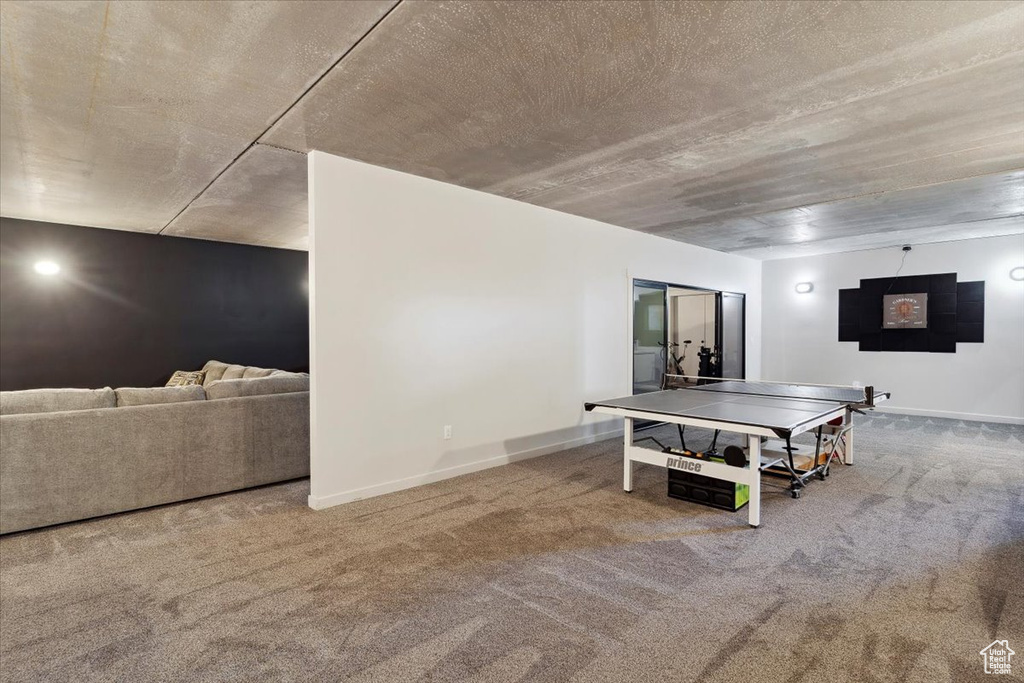 Game room featuring carpet and baseboards