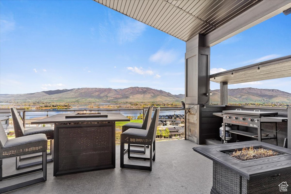 View of patio / terrace featuring a fire pit and a water and mountain view