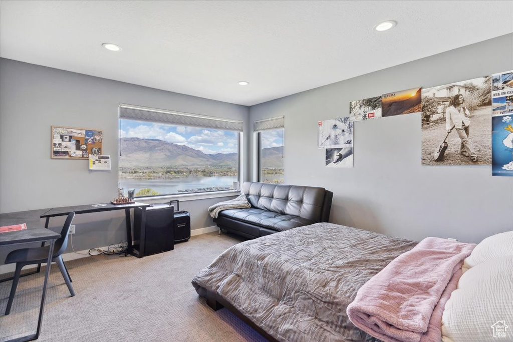 Bedroom featuring carpet flooring, recessed lighting, and a water view