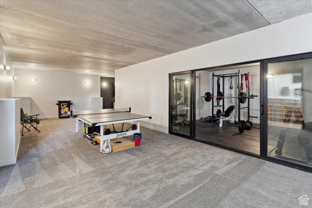 Recreation room featuring carpet floors and baseboards