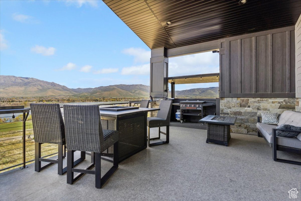 Balcony with a mountain view, a patio area, and a fire pit