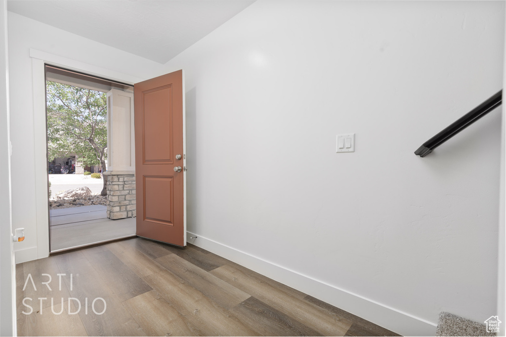 Entryway with wood finished floors and baseboards