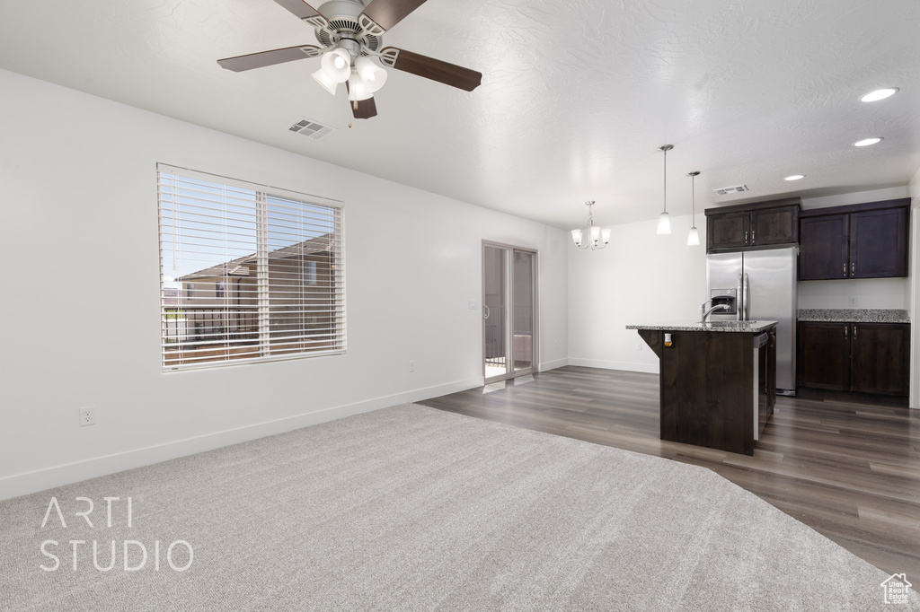 Kitchen featuring a chandelier, dark brown cabinetry, baseboards, a ceiling fan, and pendant lighting