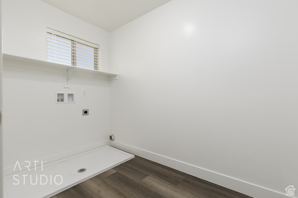 Laundry room with hookup for a washing machine, electric dryer hookup, dark wood-type flooring, and baseboards
