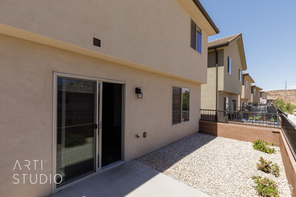 View of patio featuring fence and a residential view