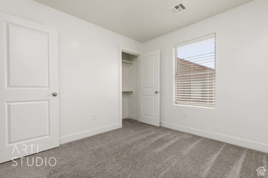 Unfurnished bedroom featuring carpet flooring and baseboards