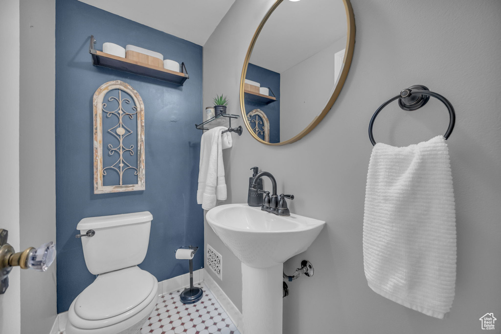 Bathroom featuring baseboards and toilet