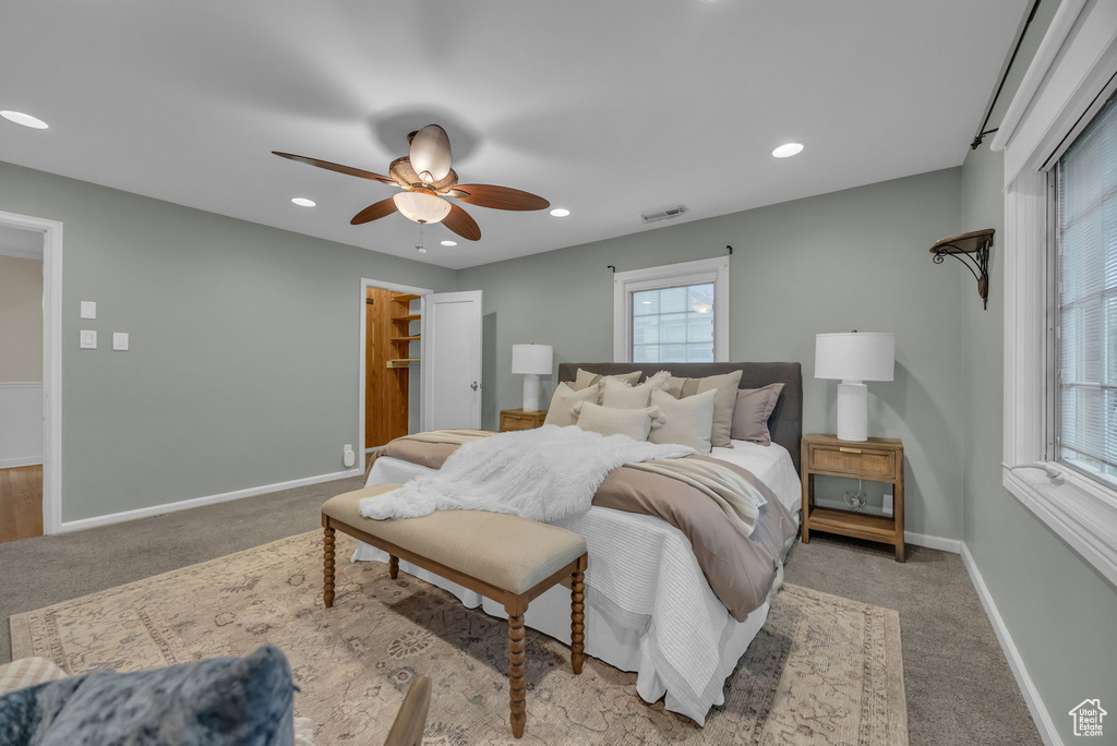 Bedroom featuring carpet, multiple windows, and recessed lighting