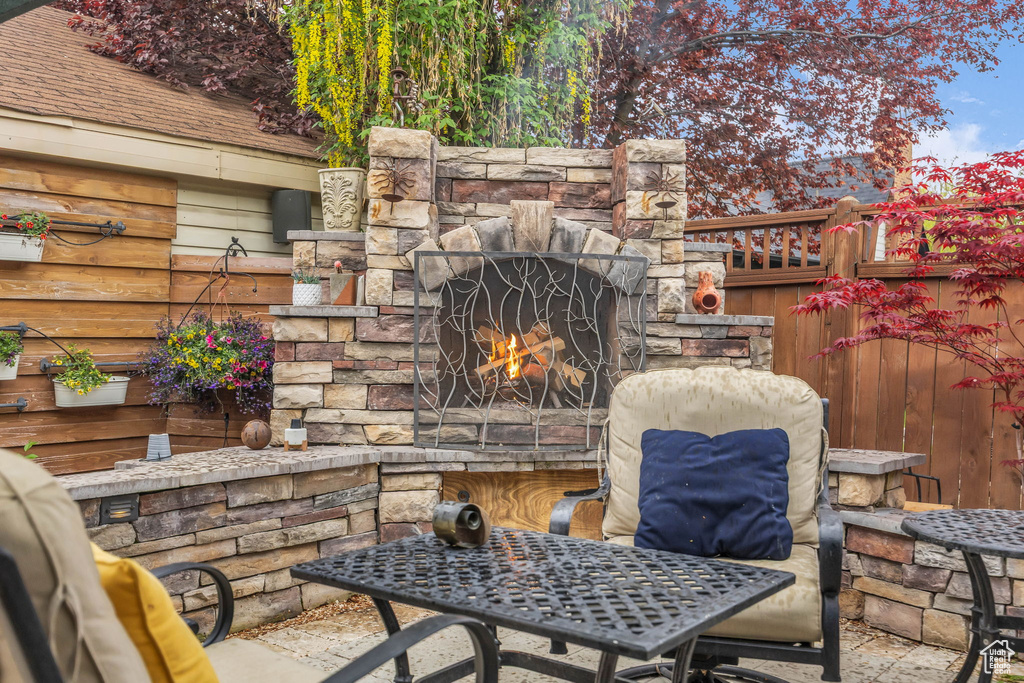 View of patio / terrace featuring an outdoor stone fireplace