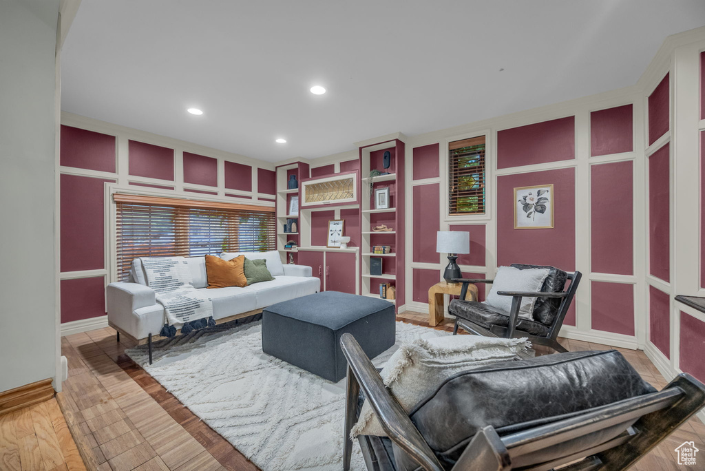 Sitting room with recessed lighting, built in features, and baseboards