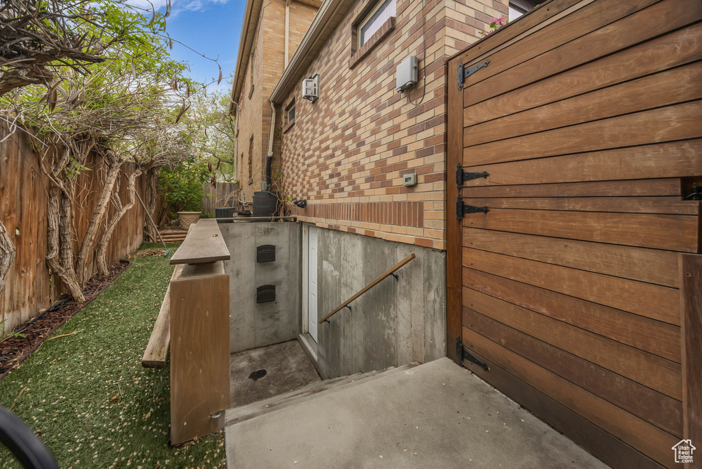 View of home\'s exterior featuring a fenced backyard and brick siding