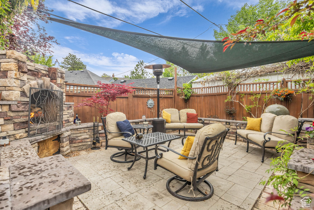 View of patio featuring an outdoor living space and a fenced backyard