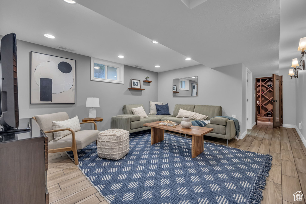 Living area featuring light wood finished floors, recessed lighting, and baseboards
