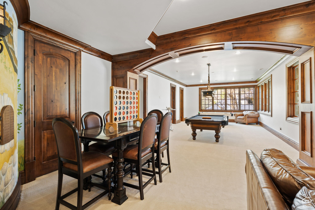 Rec room featuring light carpet, wood walls, crown molding, and billiards