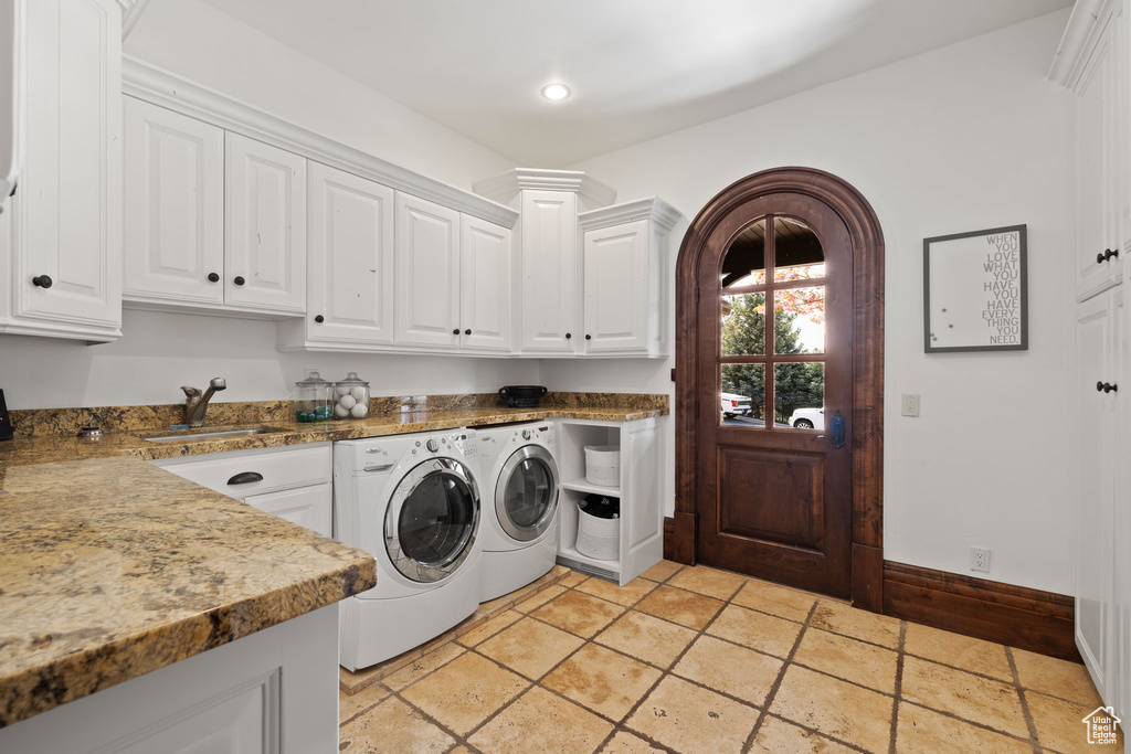 Laundry area with a sink, separate washer and dryer, cabinet space, stone tile flooring, and recessed lighting