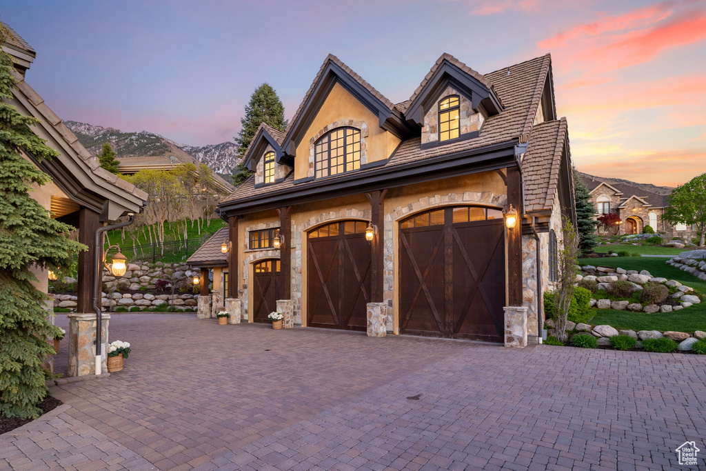 Garage with a mountain view and decorative driveway