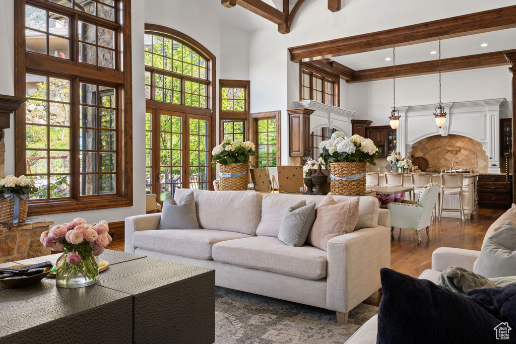 Living area featuring a high ceiling and dark wood-style floors