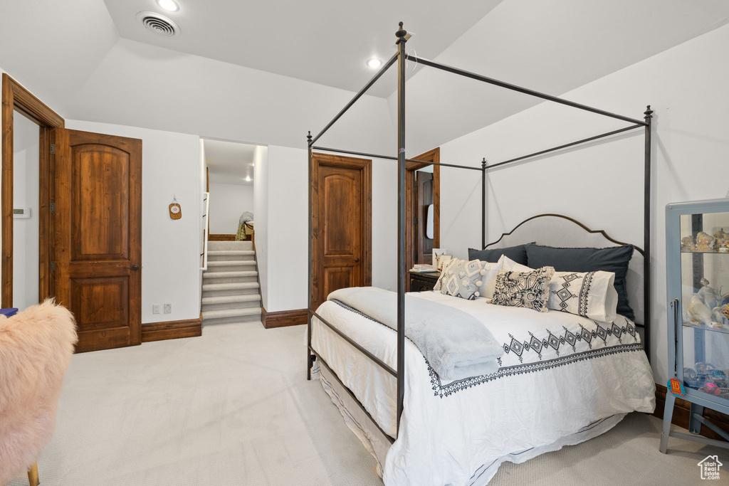 Bedroom featuring visible vents and light carpet