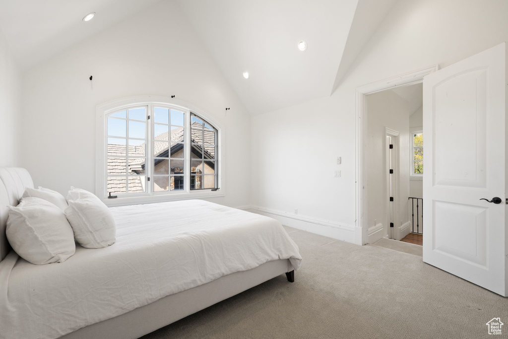 Bedroom with baseboards, recessed lighting, high vaulted ceiling, and carpet