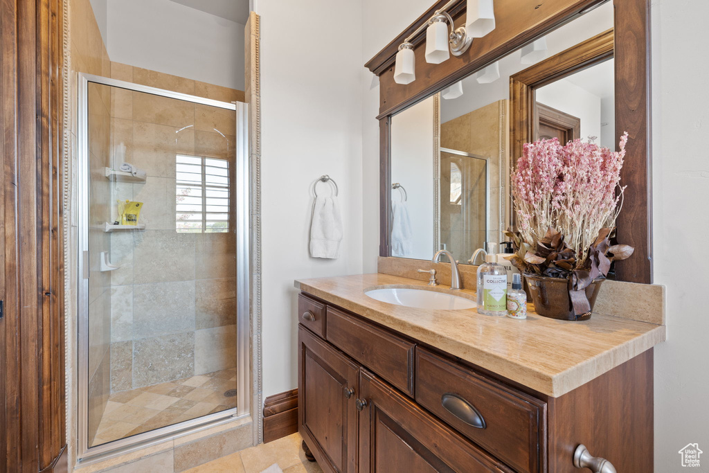 Full bath with a stall shower and vanity