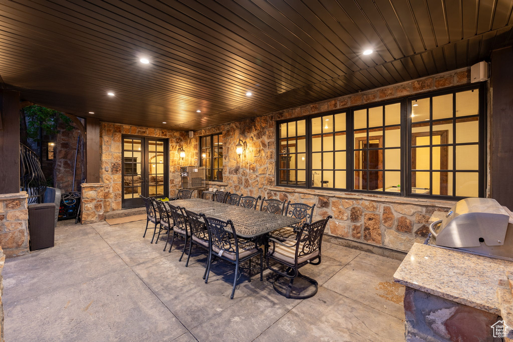 View of patio / terrace featuring exterior kitchen, french doors, and outdoor dining space