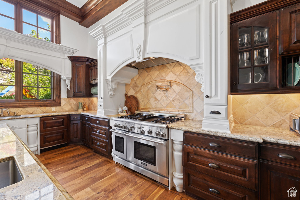 Kitchen with double oven range, a healthy amount of sunlight, and tasteful backsplash