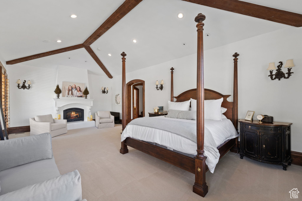 Bedroom featuring light carpet, lofted ceiling with beams, and recessed lighting