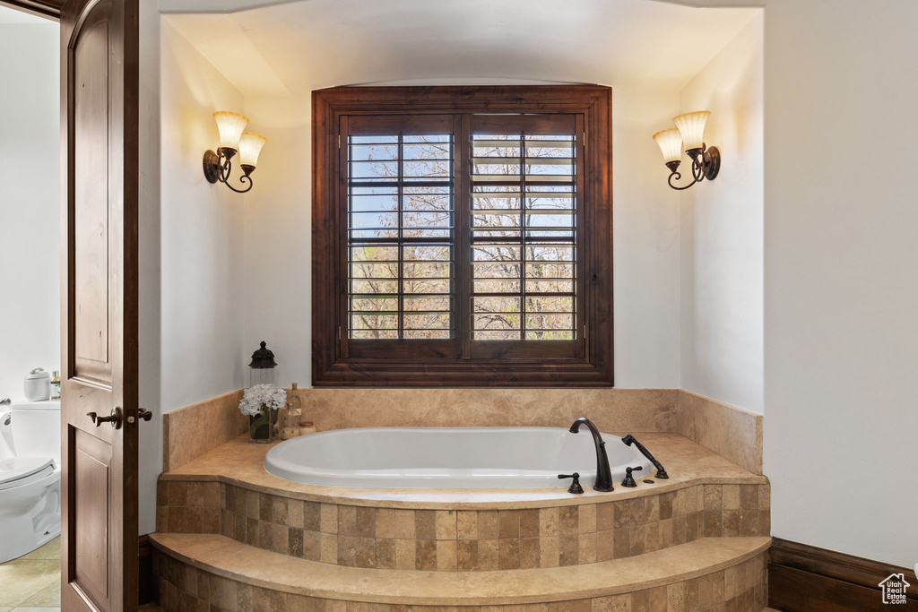 Bathroom featuring toilet and a bath