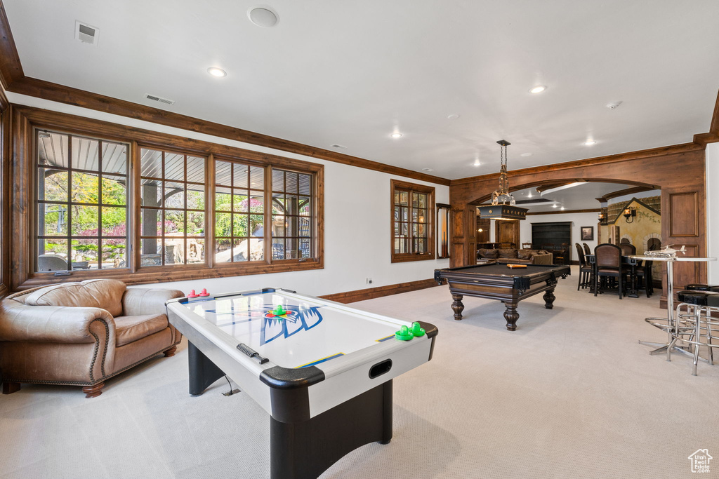Playroom with light colored carpet, ornamental molding, pool table, visible vents, and arched walkways