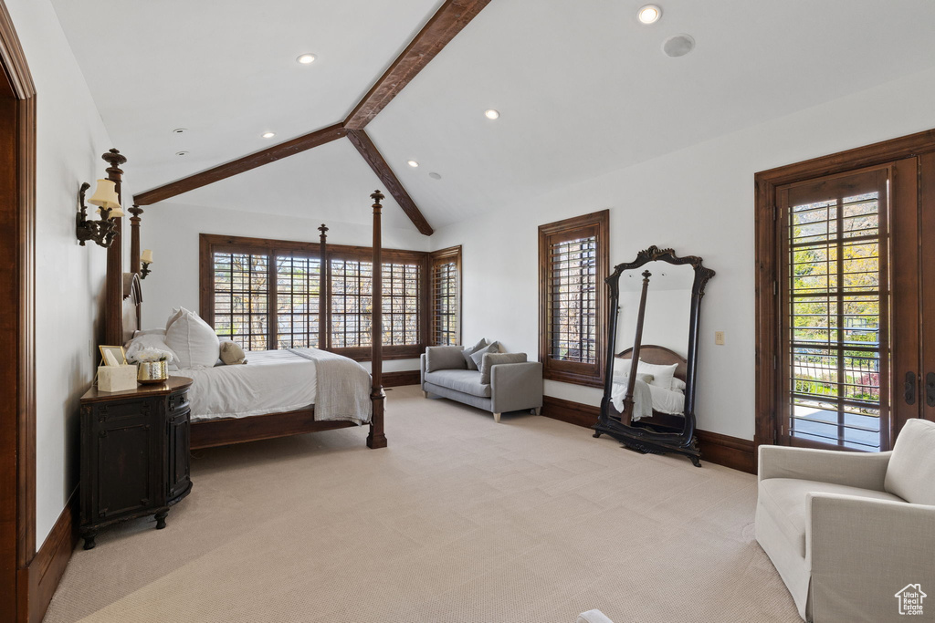 Bedroom featuring multiple windows, light carpet, baseboards, and lofted ceiling with beams