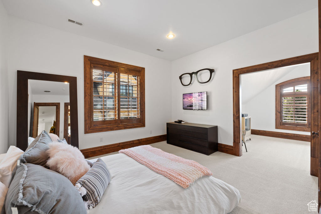 Carpeted bedroom with visible vents, baseboards, and recessed lighting
