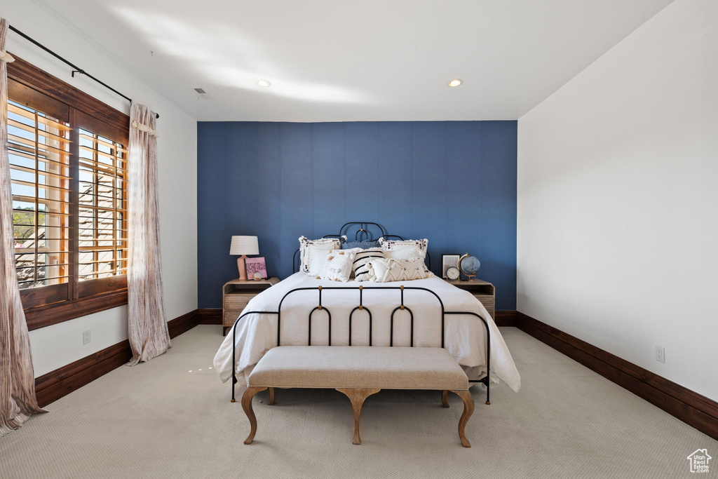 Bedroom featuring baseboards, recessed lighting, an accent wall, and carpet floors