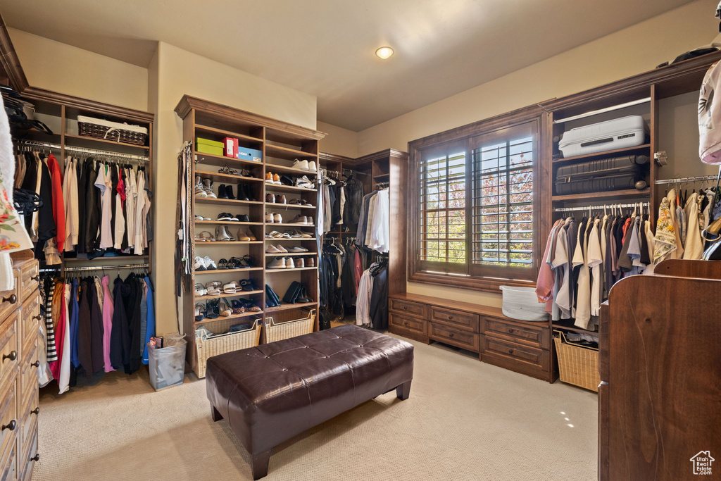 Spacious closet with light colored carpet and a wall mounted AC