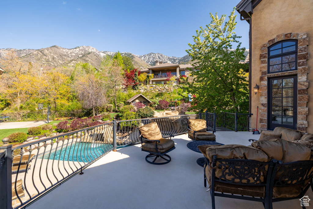 View of patio with a mountain view and an outdoor pool
