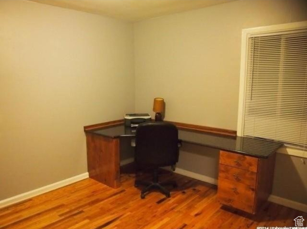 Office space with wood finished floors and baseboards