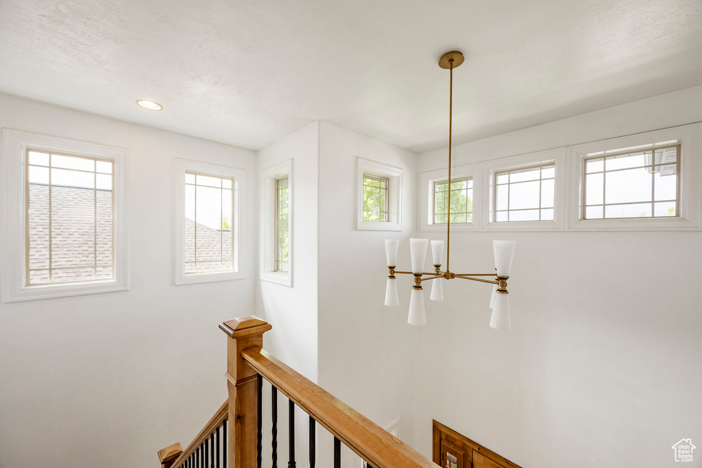 Corridor featuring an upstairs landing and recessed lighting