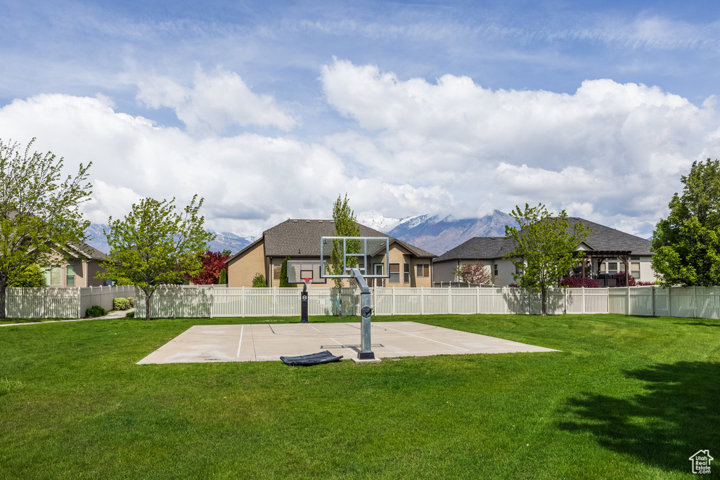 View of yard featuring basketball hoop