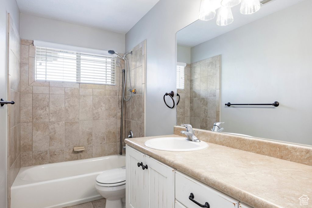 Bathroom featuring shower / bathing tub combination, vanity, and toilet