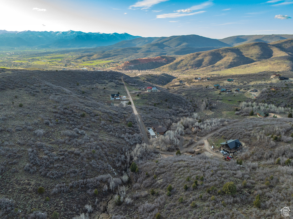 Aerial view of property and surrounding area with mountains