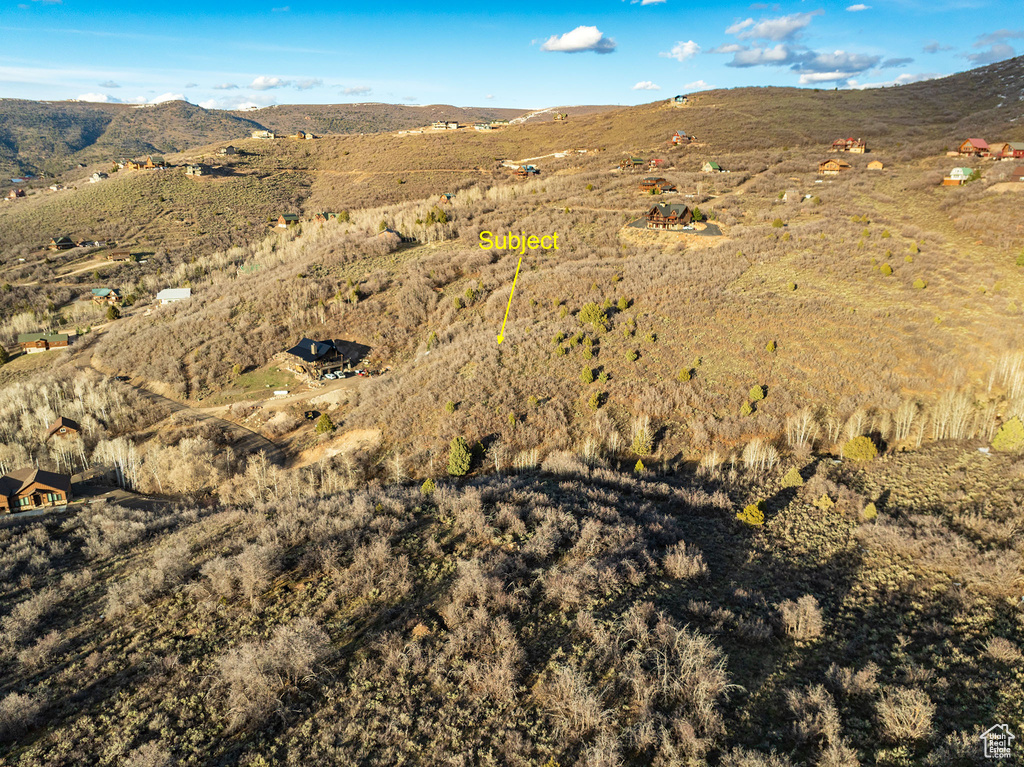 Aerial view of property and surrounding area with mountains