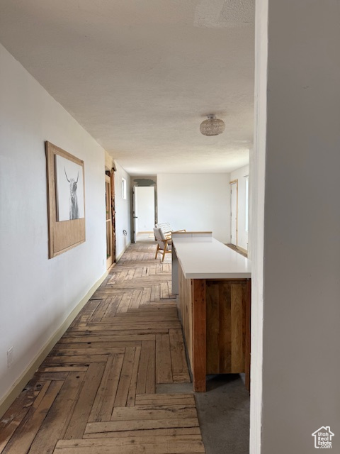 Corridor featuring baseboards
