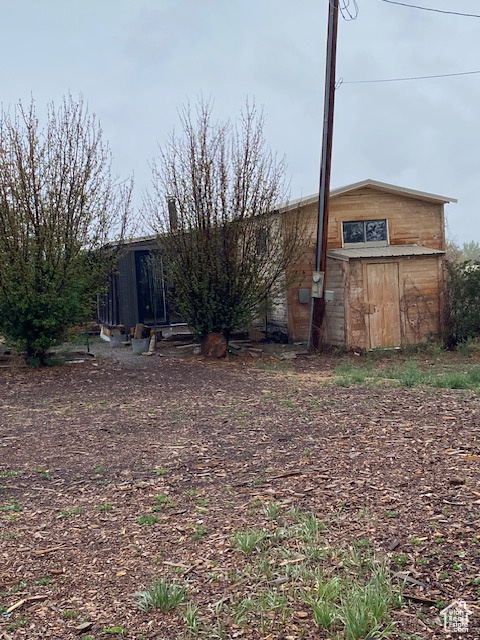 View of yard featuring an outdoor structure and a storage unit