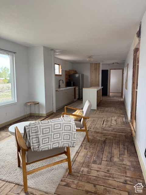 Living room with baseboards and parquet flooring