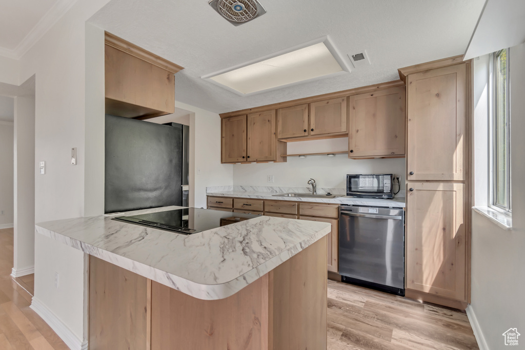 Kitchen featuring black appliances, a sink, light wood-type flooring, and baseboards